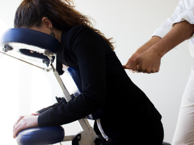 Aplicação da técnica de quick massage em cadeira específica, focando no alívio rápido de tensões.